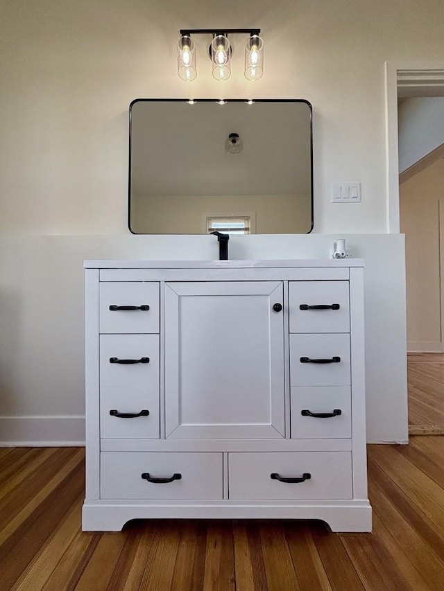 interior details with wood-type flooring and vanity