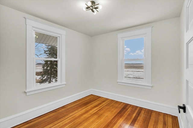 unfurnished room featuring hardwood / wood-style floors