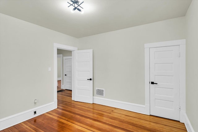 spare room featuring hardwood / wood-style flooring