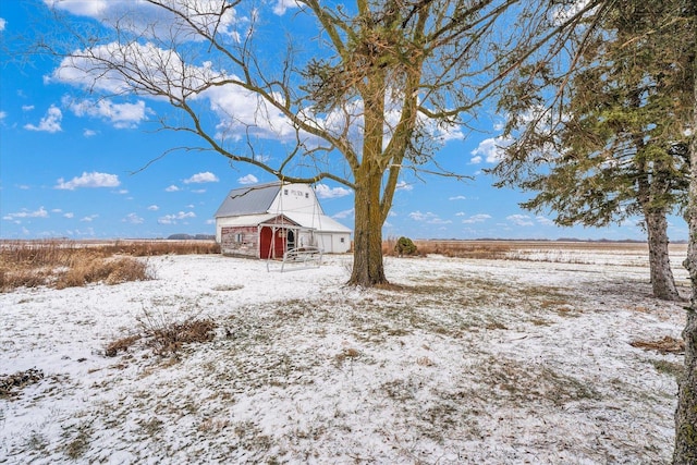 snowy yard with an outbuilding