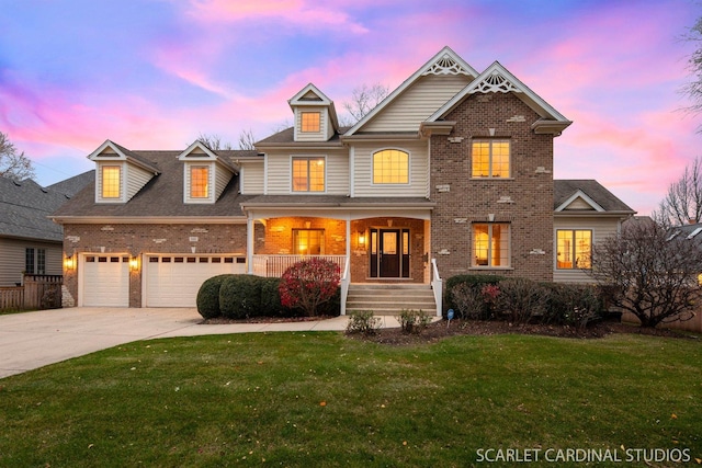 craftsman-style home with a garage, a yard, and covered porch