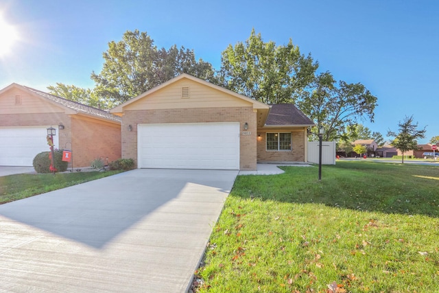 ranch-style house featuring a garage and a front yard