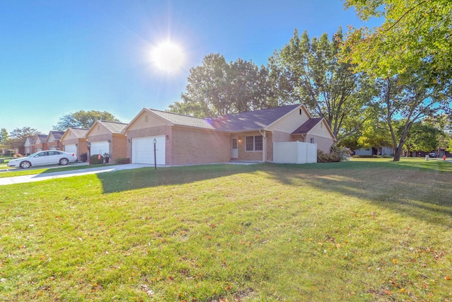 single story home featuring a garage and a front lawn