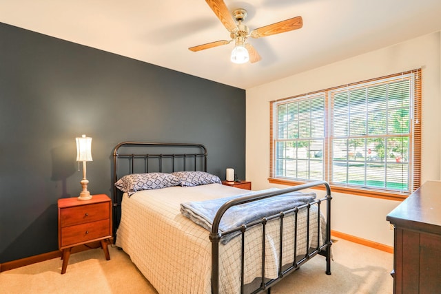 bedroom with light carpet and ceiling fan