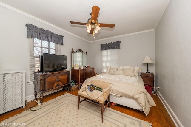 bedroom with hardwood / wood-style flooring, radiator heating unit, ornamental molding, and ceiling fan