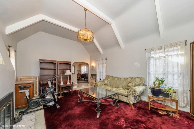 carpeted living room with a chandelier and high vaulted ceiling