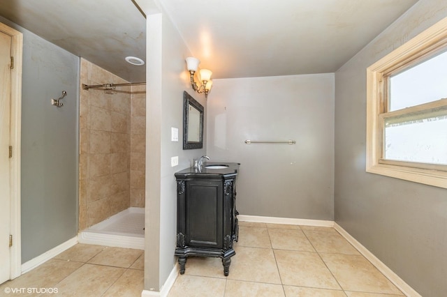 bathroom with vanity, tile patterned flooring, and a tile shower