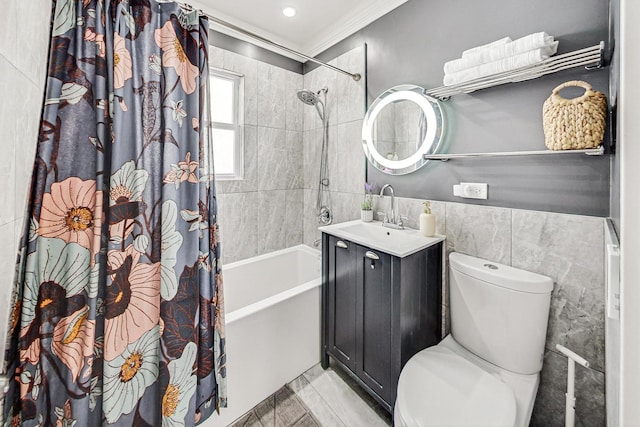 full bathroom featuring shower / bath combination with curtain, ornamental molding, vanity, tile walls, and toilet