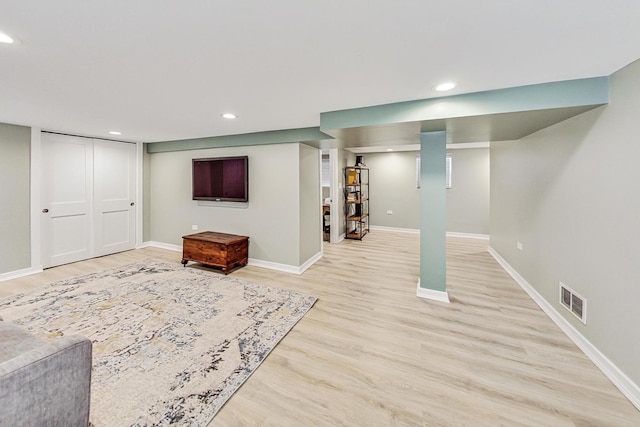 basement with light hardwood / wood-style flooring