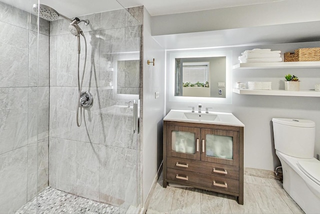 bathroom with vanity, toilet, and an enclosed shower