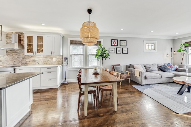 dining room featuring dark hardwood / wood-style floors and crown molding