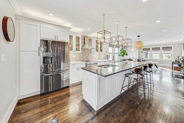 kitchen with a kitchen island with sink, sink, white cabinets, and stainless steel appliances