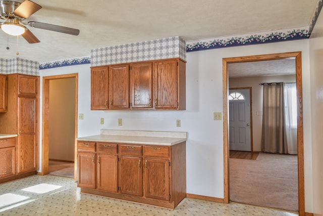 kitchen featuring a textured ceiling and ceiling fan