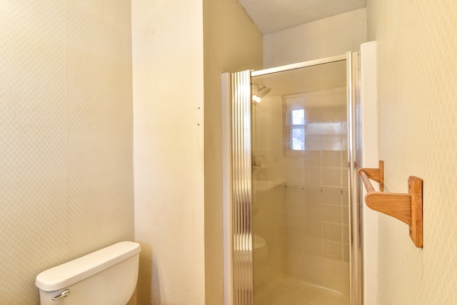 bathroom featuring toilet and an enclosed shower