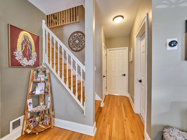 staircase with wood-type flooring