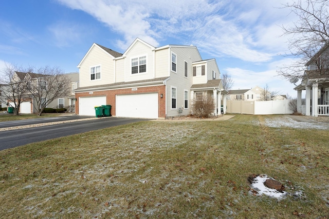 view of front of property featuring a garage and a front lawn