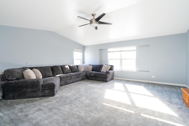 living room with carpet, ceiling fan, a wealth of natural light, and vaulted ceiling