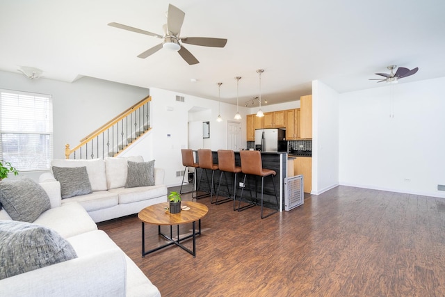 living room featuring dark hardwood / wood-style floors and ceiling fan