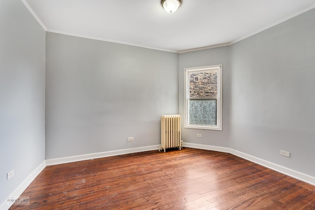 unfurnished room featuring hardwood / wood-style floors, ornamental molding, and radiator