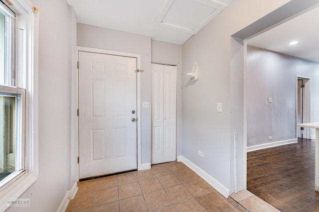 foyer entrance featuring light tile patterned flooring and a wealth of natural light