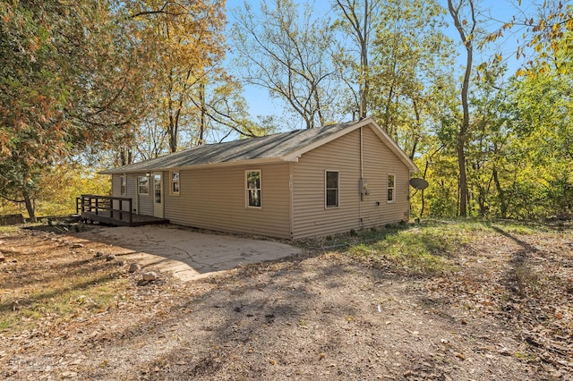 view of property exterior with a deck