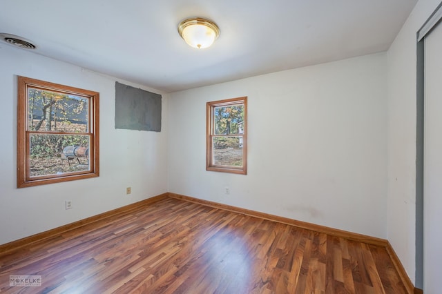 unfurnished room featuring dark hardwood / wood-style floors