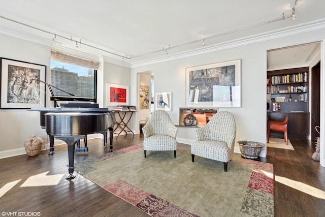 sitting room featuring track lighting, crown molding, and dark hardwood / wood-style floors