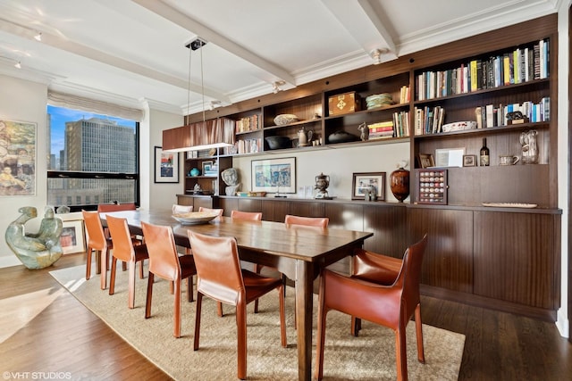 dining room featuring hardwood / wood-style flooring, beam ceiling, and crown molding