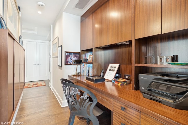 office area featuring built in desk and light hardwood / wood-style flooring