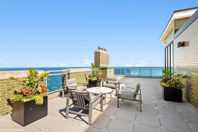 view of patio featuring a balcony, an outdoor living space, and a water view