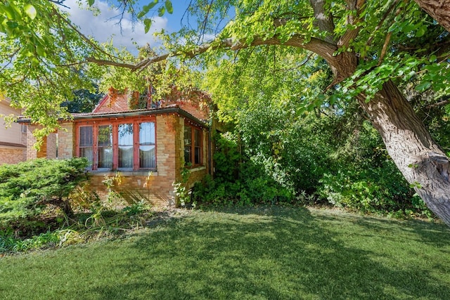 view of home's exterior with a lawn