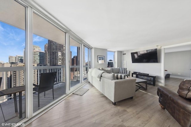 living room with hardwood / wood-style flooring and a wall of windows