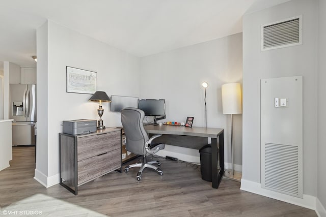 home office with wood-type flooring