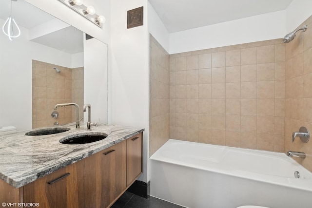 bathroom with vanity and tiled shower / bath combo