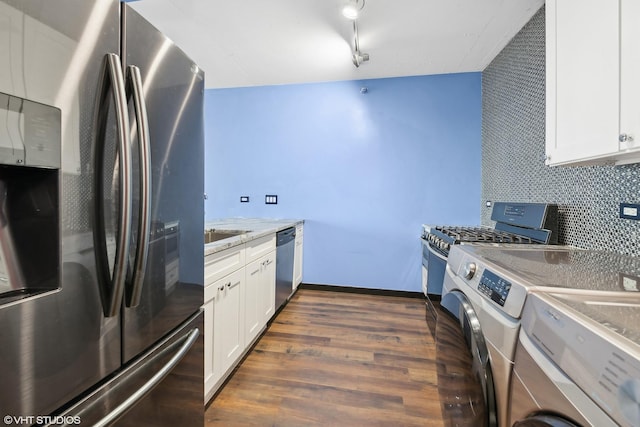 kitchen with stainless steel appliances, white cabinetry, dark wood-type flooring, and decorative backsplash