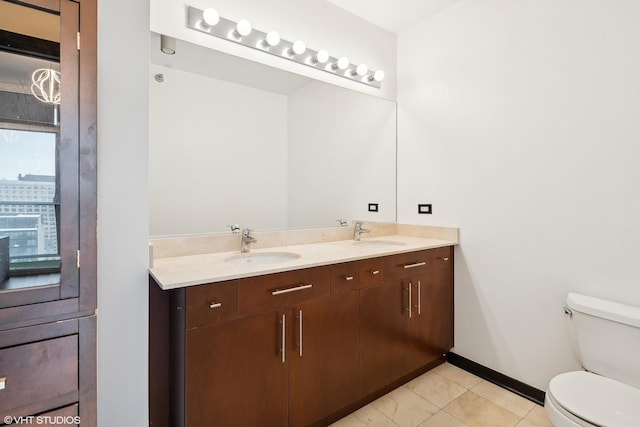 bathroom with tile patterned flooring, vanity, and toilet