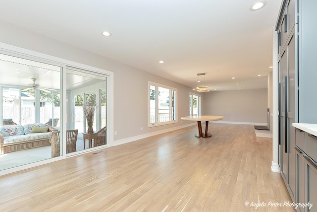 interior space with light wood-type flooring, plenty of natural light, and ceiling fan