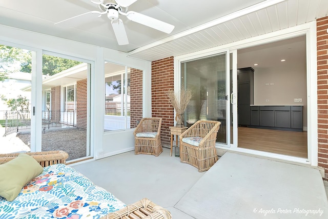 sunroom featuring ceiling fan