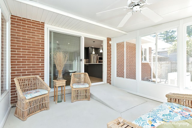 sunroom / solarium featuring ceiling fan