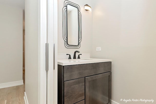 bathroom with hardwood / wood-style floors and vanity