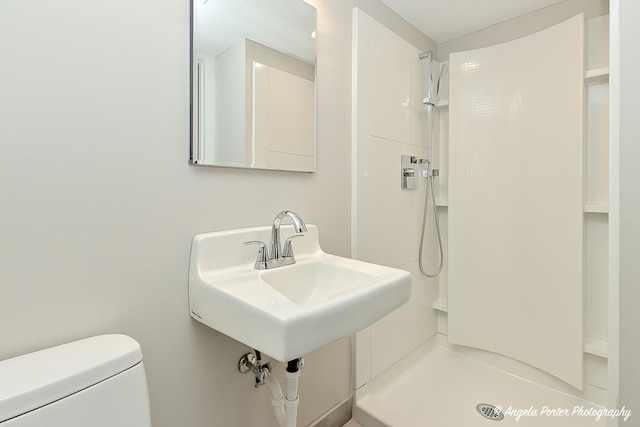 bathroom with walk in shower and toilet