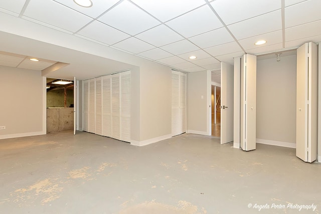 basement with a paneled ceiling