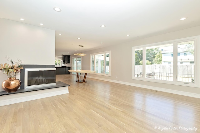 unfurnished living room featuring light hardwood / wood-style floors