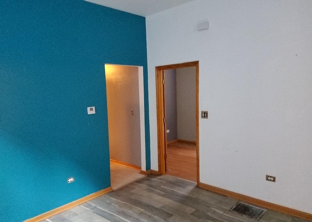 unfurnished room with hardwood / wood-style flooring