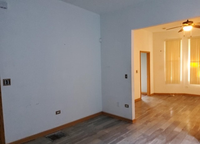 unfurnished room with ceiling fan and wood-type flooring