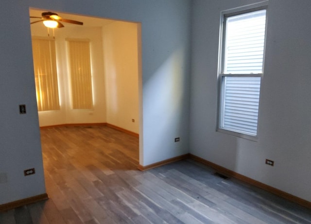 unfurnished room featuring ceiling fan and hardwood / wood-style flooring