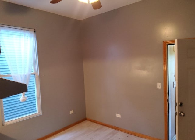 spare room featuring light wood-type flooring and ceiling fan