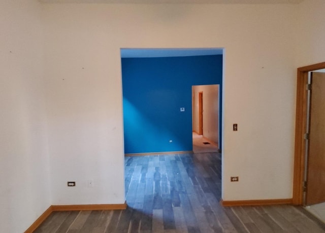 empty room featuring dark wood-type flooring