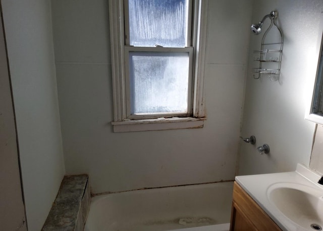 bathroom with a washtub and vanity