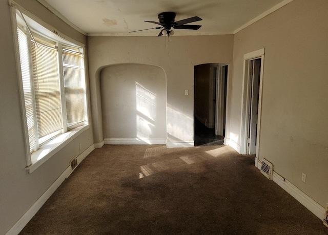 carpeted empty room with crown molding, ceiling fan, and a healthy amount of sunlight